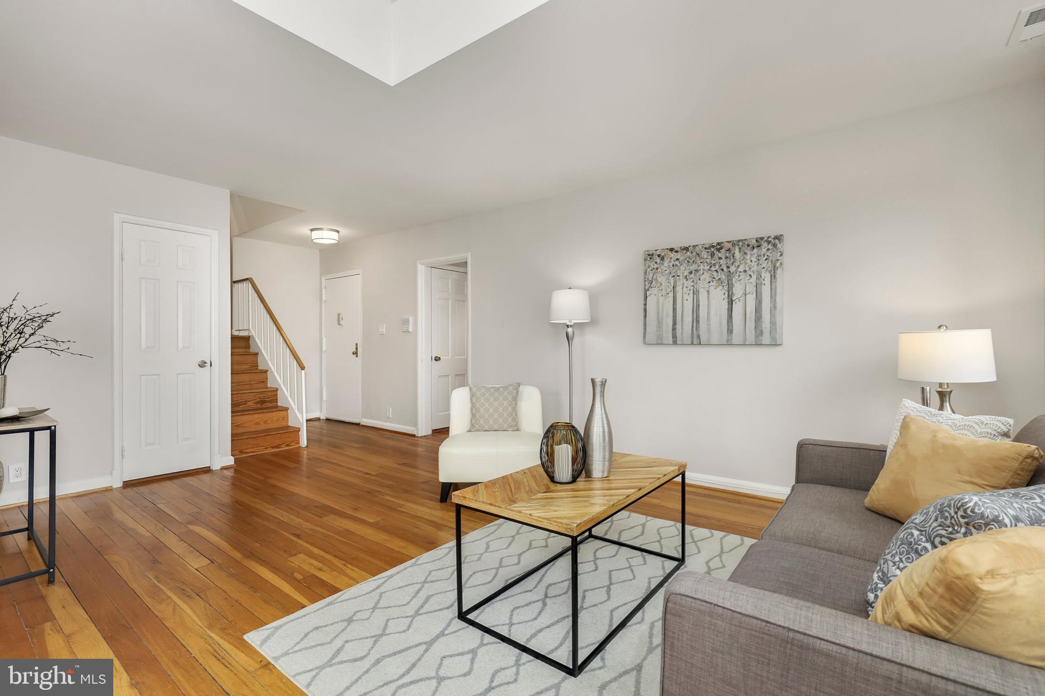 3831 Rodman Street Northwest, Unit F30 Washington, DC 20016 - Photo 7 of 33 a living room with furniture and a wooden floor