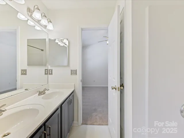 a bathroom with a double vanity sink and a mirror