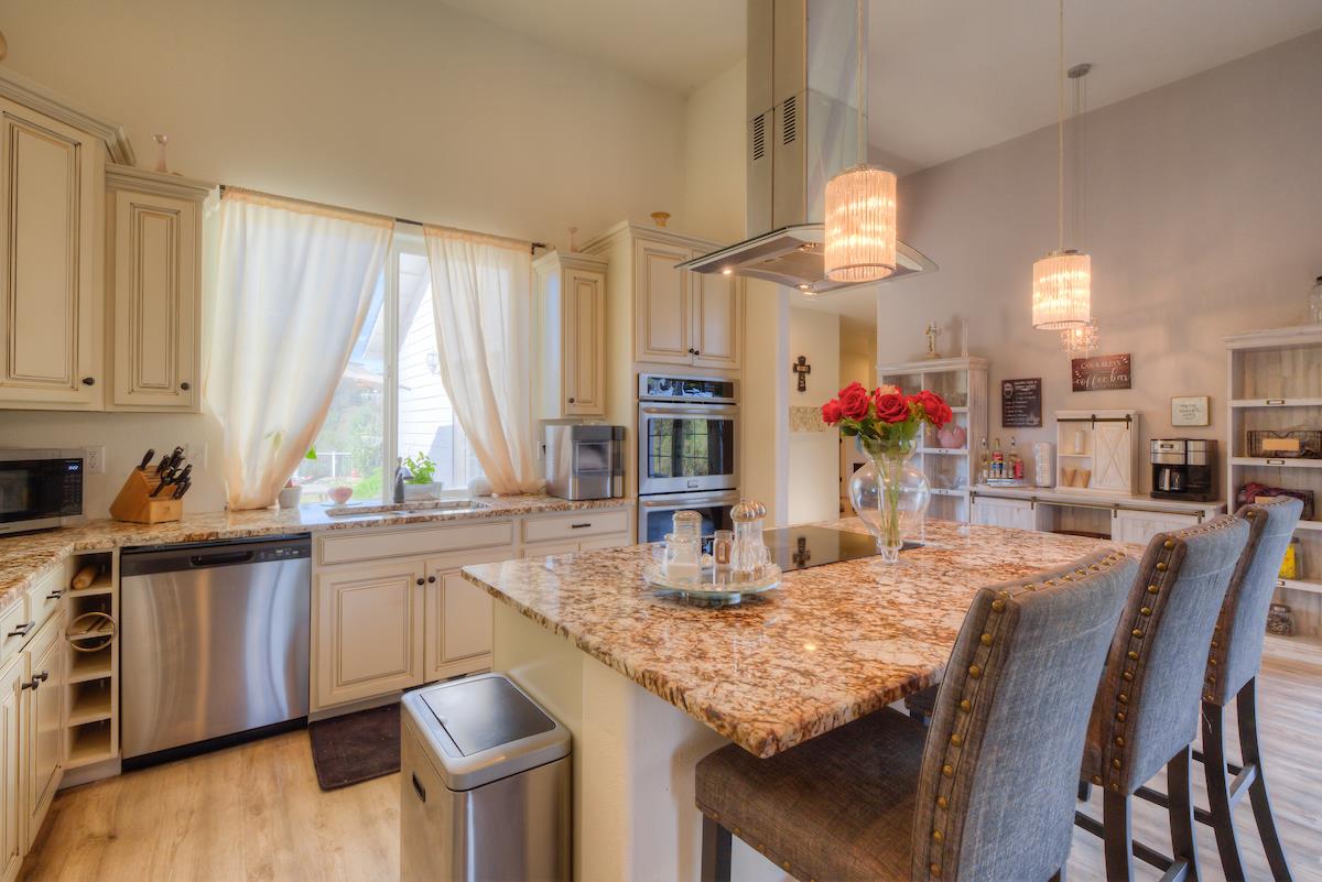 83 Northfork Road Berry Creek, CA 95916 - Photo 27 of 56 a dining table with chairs and cabinets