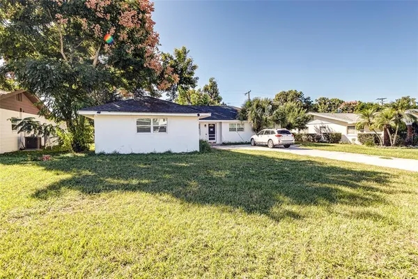 a view of a house with a yard and garage