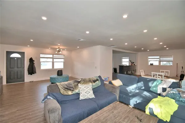 a view of a hallway with wooden floor and closet area