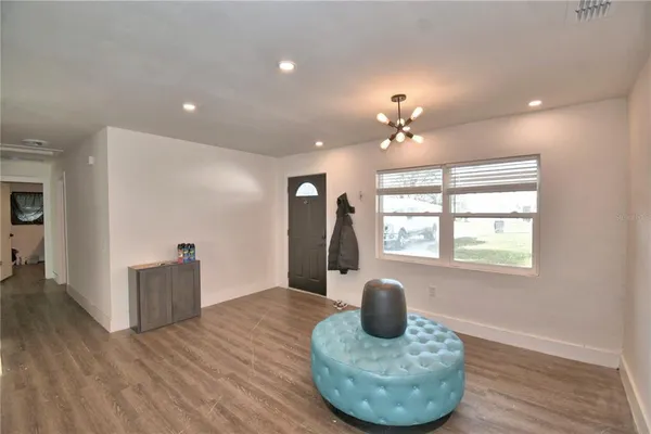 a living room with furniture and a wooden floor