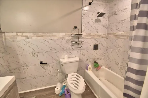 a bathroom with a shower and a mirror