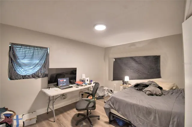 a bedroom with a bed and a mirror