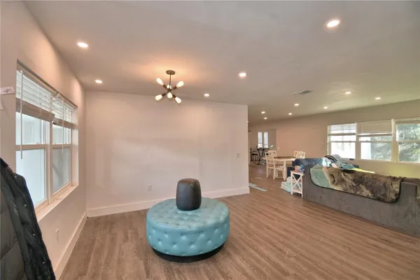 a living room with furniture and a chandelier