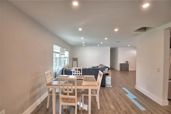 a view of a a dining room with furniture window and wooden floor