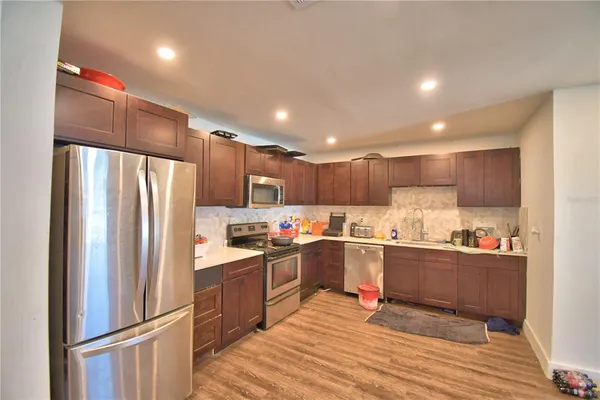 a kitchen with stainless steel appliances a refrigerator stove microwave and cabinets
