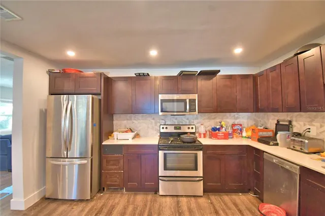 a kitchen with stainless steel appliances granite countertop a sink and cabinets