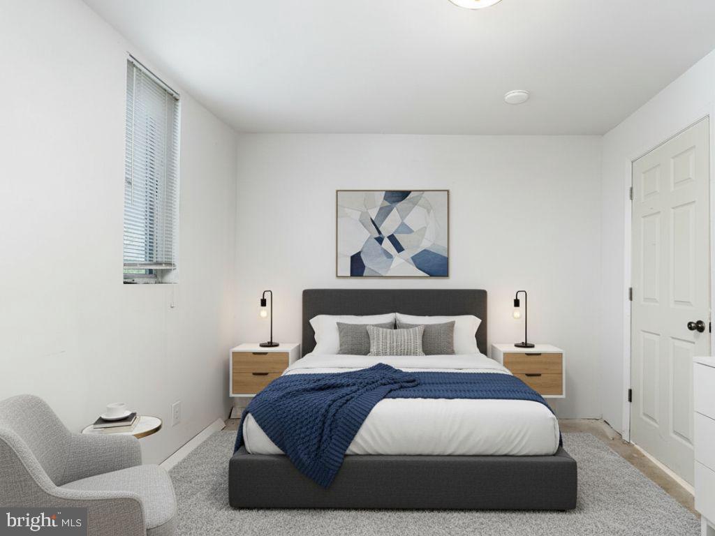 2544 West Fairmount Avenue Baltimore, MD 21223 - Photo 16 of 20 a bedroom with a bed and a painting on the wall