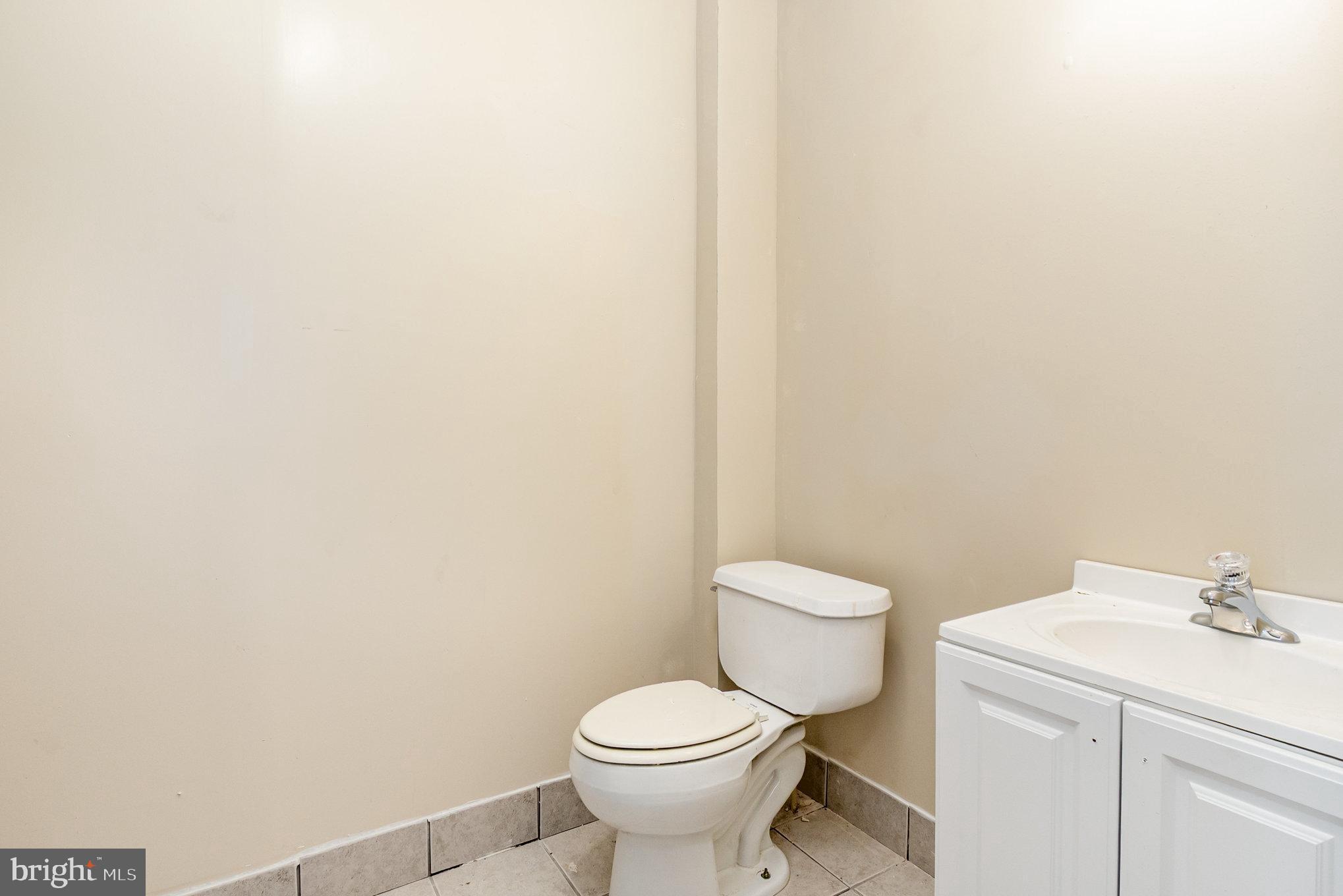 2544 West Fairmount Avenue Baltimore, MD 21223 - Photo 17 of 20 a white toilet sitting next to a white sink