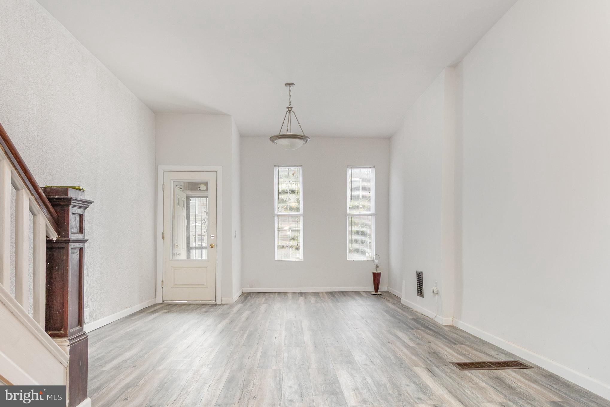 2544 West Fairmount Avenue Baltimore, MD 21223 - Photo 6 of 20 an empty room with wooden floor and windows
