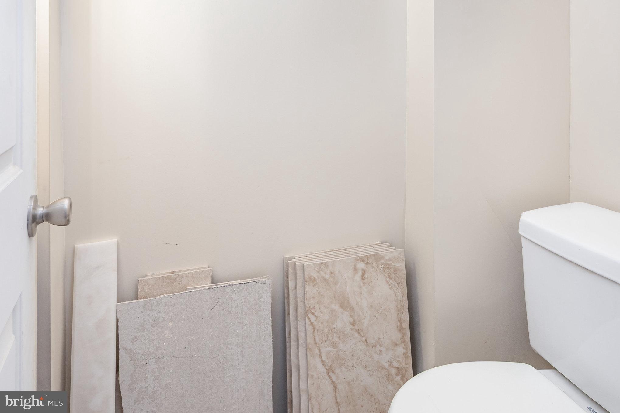 2544 West Fairmount Avenue Baltimore, MD 21223 - Photo 9 of 20 a white toilet sitting next to a shower