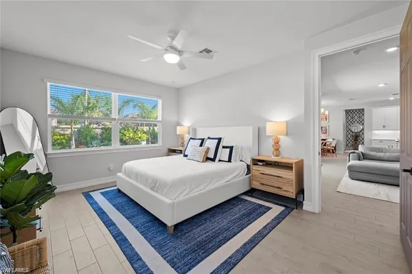 a bedroom with a large bed and a chandelier