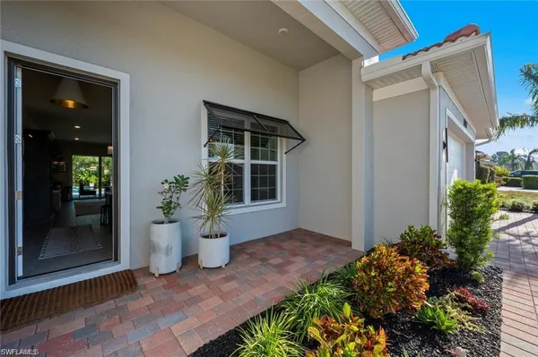 a view of a house with potted plants