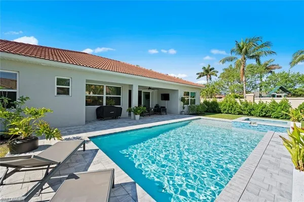 a view of a house with backyard sitting area and garden