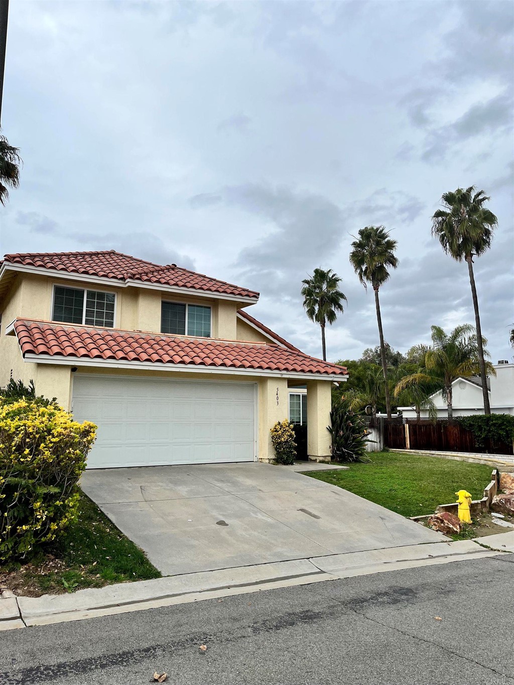 5403 Elderberry Way Oceanside, CA 92057 - Photo 2 of 19 a front view of a house with a yard and garage