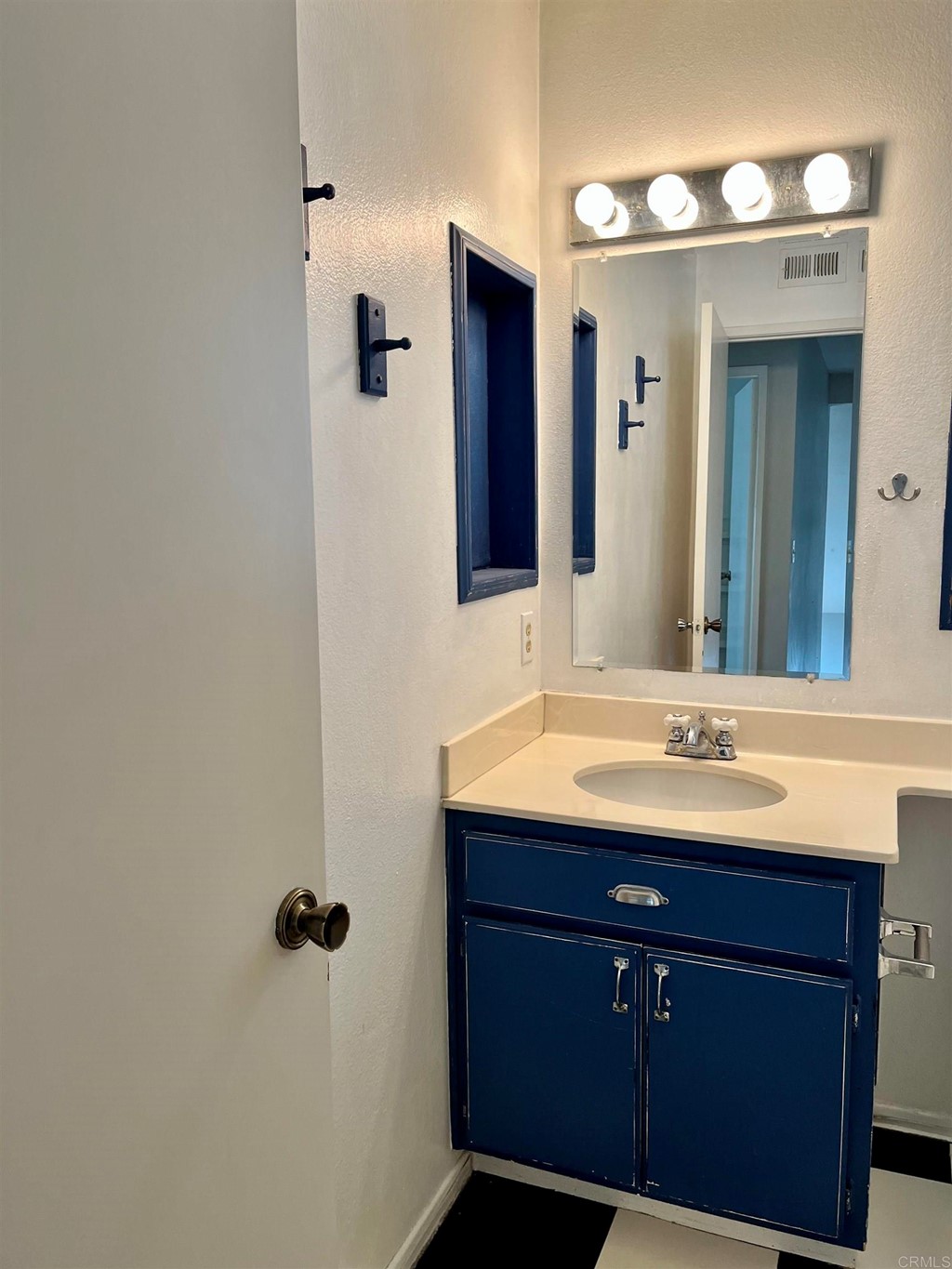5403 Elderberry Way Oceanside, CA 92057 - Photo 15 of 19 a bathroom with a sink and a mirror
