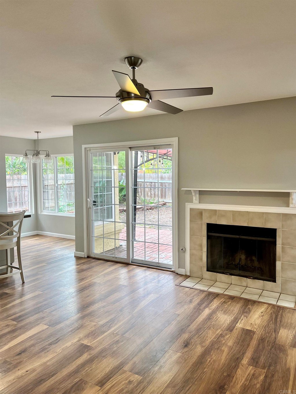 5403 Elderberry Way Oceanside, CA 92057 - Photo 6 of 19 a view of an empty room with wooden floor fireplace and a window