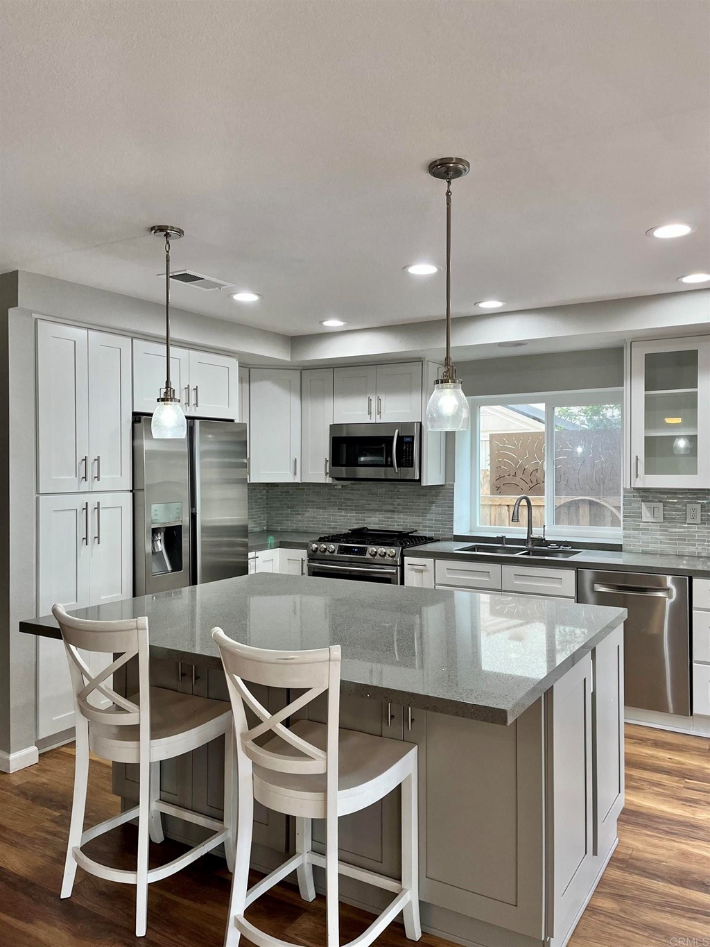5403 Elderberry Way Oceanside, CA 92057 - Photo 8 of 19 a kitchen with kitchen island a counter space a sink appliances and cabinets
