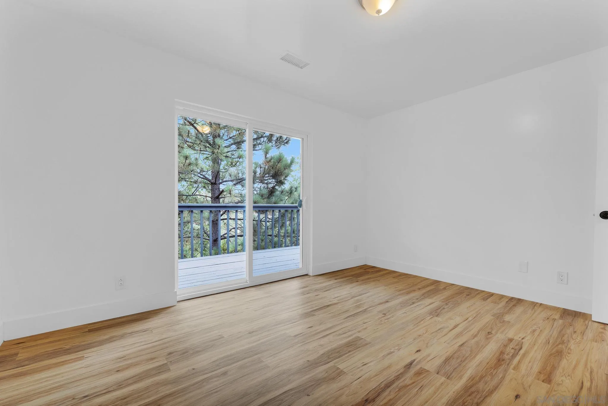 859 Pine Cone Drive Julian, CA 92036 - Photo 25 of 43 wooden floor in an empty room with a window