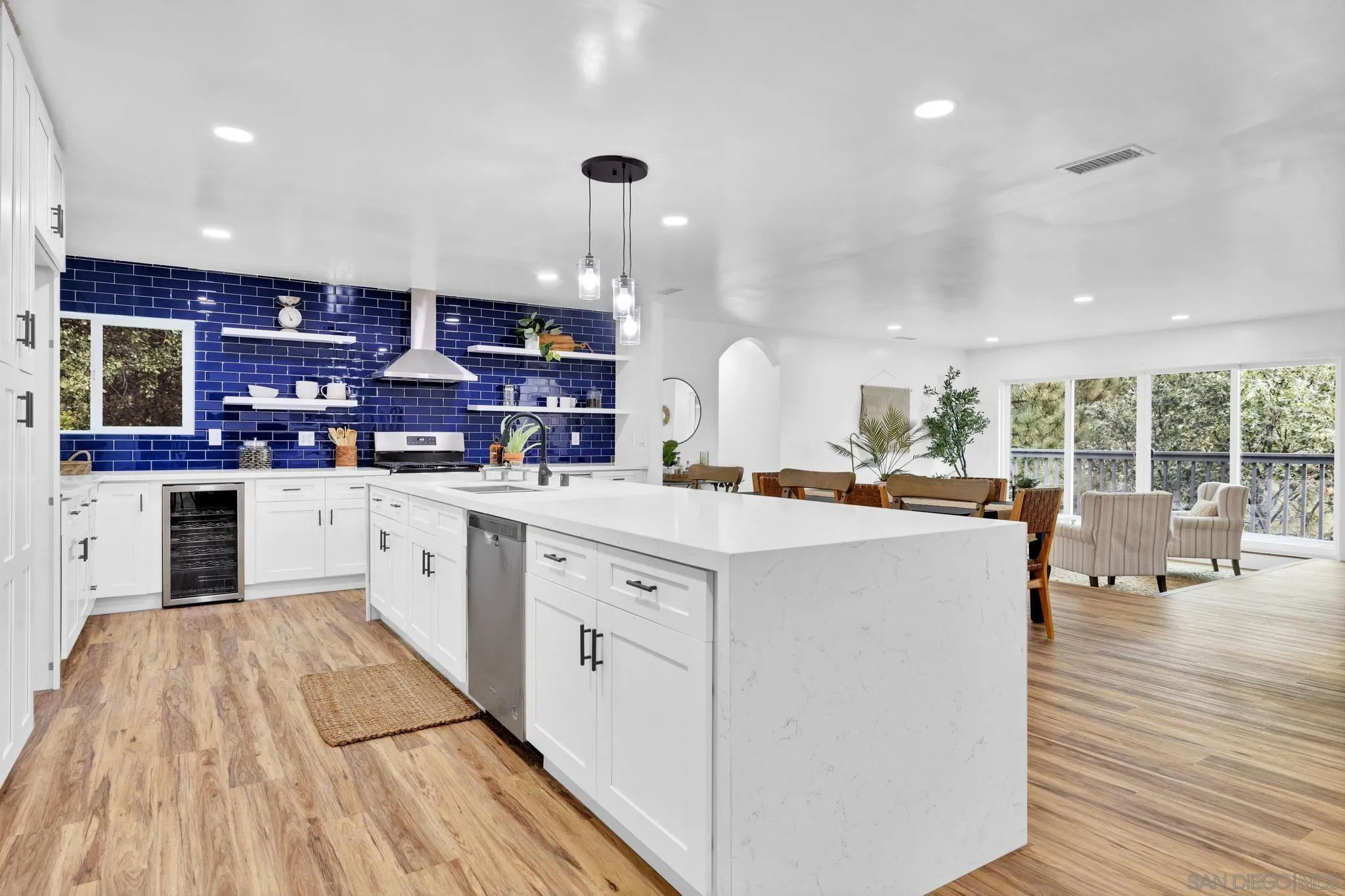 859 Pine Cone Drive Julian, CA 92036 - Photo 8 of 43 a large kitchen with stainless steel appliances a large counter top a stove and a wooden floors