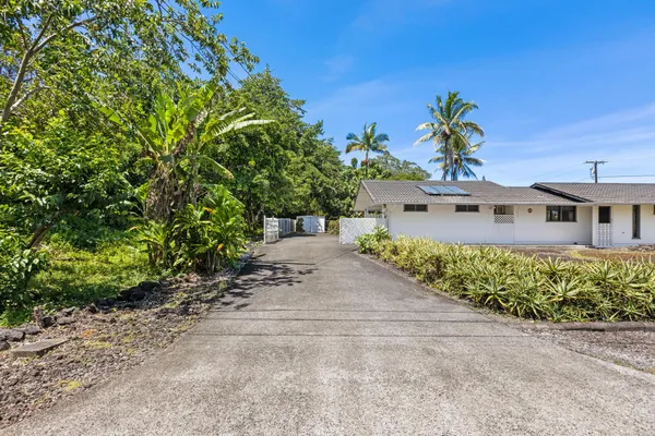 an aerial view of a house with a yard and garden