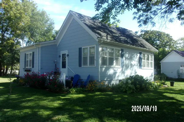 a front view of house with a garden and patio