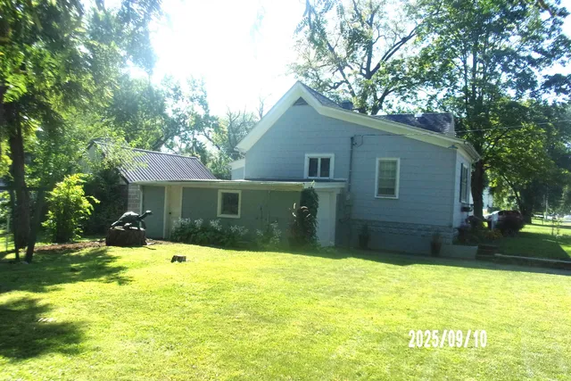a front view of house with yard and trees
