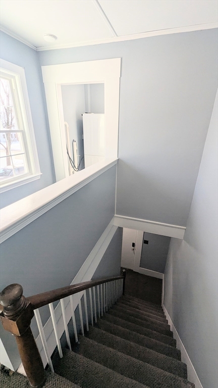 69 Main Street, Unit 2 Foxboro, MA 02035 - Photo 16 of 17 a view of a livingroom with wooden floor and white walls