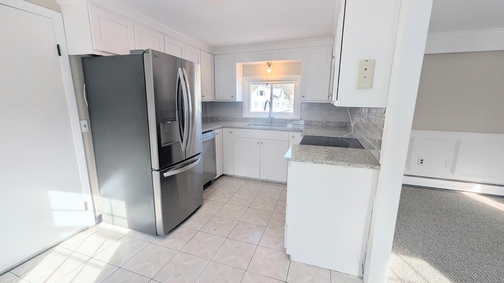 69 Main Street, Unit 2 Foxboro, MA 02035 - Photo 7 of 17 a kitchen with a refrigerator sink and cabinets