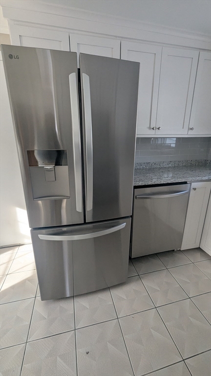 69 Main Street, Unit 2 Foxboro, MA 02035 - Photo 10 of 17 a kitchen with stainless steel appliances granite countertop a refrigerator and cabinets