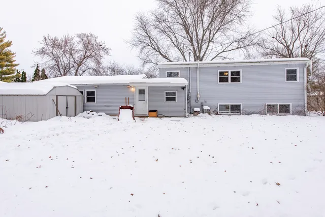 a view of a house with snow on the background