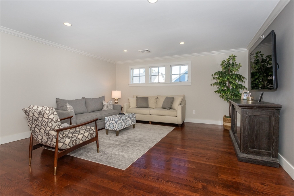 8 Cooks Farm Road, Unit 8 Franklin, MA 02038 - Photo 17 of 30 a living room with furniture a potted plant and a wooden floor