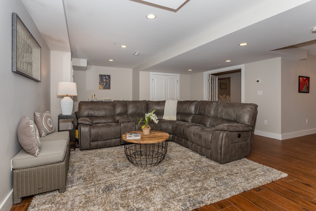 8 Cooks Farm Road, Unit 8 Franklin, MA 02038 - Photo 20 of 30 a living room with furniture and a wooden floor