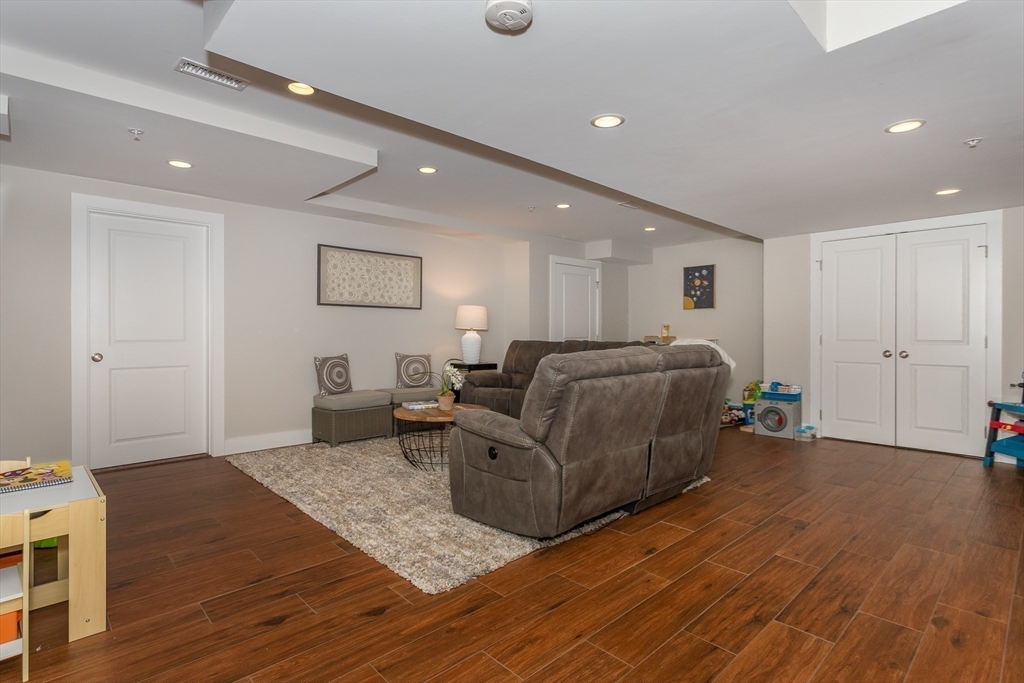 8 Cooks Farm Road, Unit 8 Franklin, MA 02038 - Photo 21 of 30 a living room with furniture and a wooden floor
