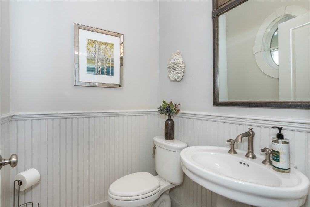 8 Cooks Farm Road, Unit 8 Franklin, MA 02038 - Photo 22 of 30 a bathroom with a toilet a sink and mirror