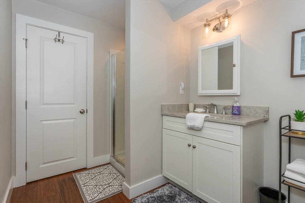 8 Cooks Farm Road, Unit 8 Franklin, MA 02038 - Photo 24 of 30 a bathroom with a sink and a mirror