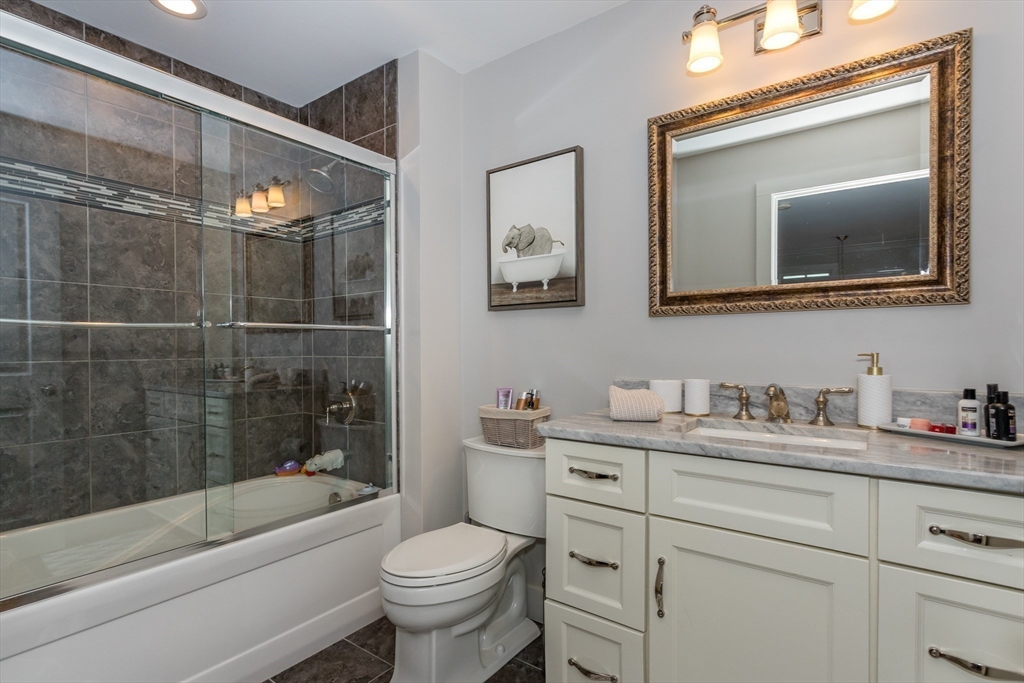 8 Cooks Farm Road, Unit 8 Franklin, MA 02038 - Photo 25 of 30 a bathroom with a toilet a sink a vanity a bathtub and a shower