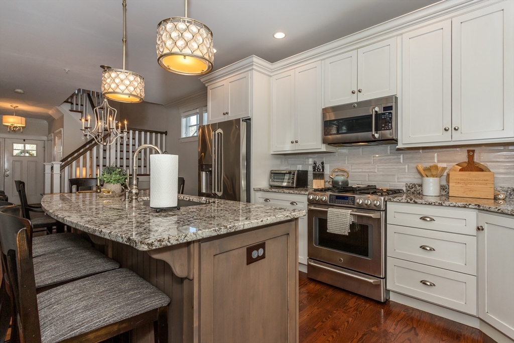8 Cooks Farm Road, Unit 8 Franklin, MA 02038 - Photo 3 of 30 a kitchen with stainless steel appliances granite countertop a lot of counter space cabinets and appliances
