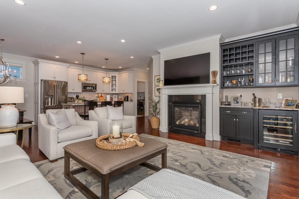 8 Cooks Farm Road, Unit 8 Franklin, MA 02038 - Photo 5 of 30 a living room with furniture a flat screen tv and a fireplace
