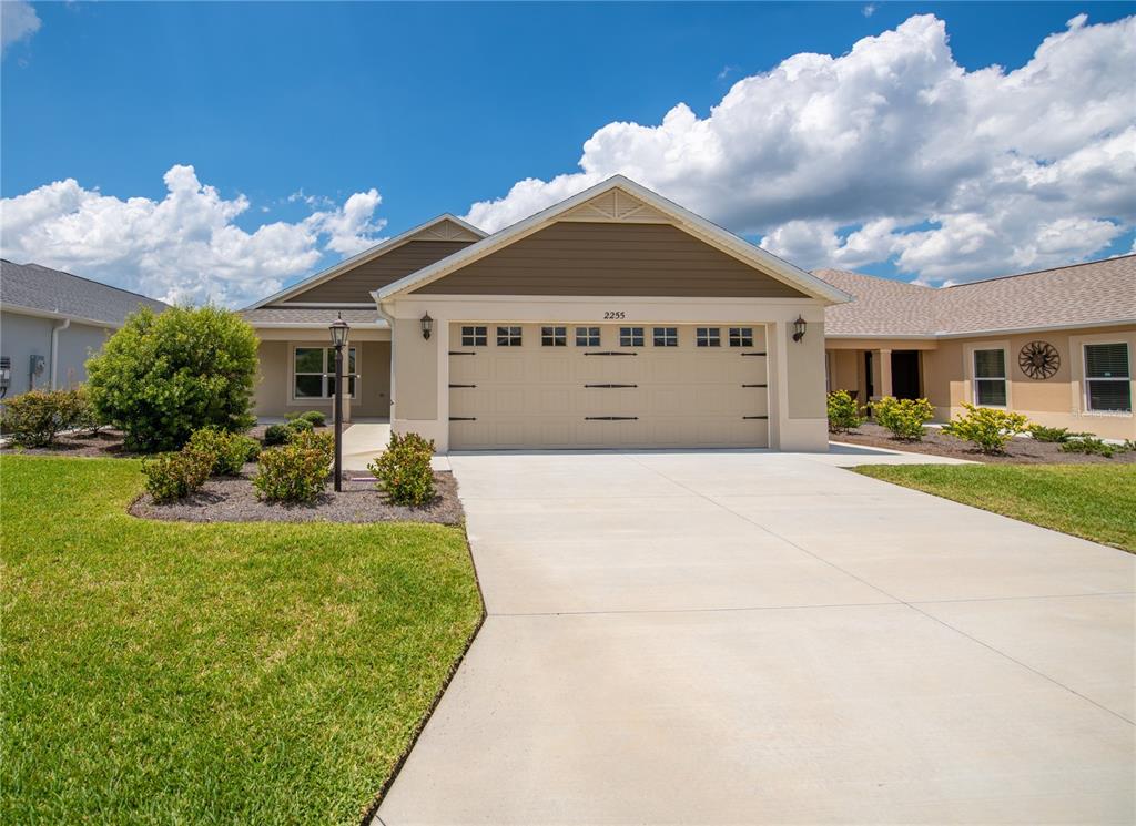 2255 Patricia Place The Villages, FL 32163 - Photo 1 of 1 a front view of a house with garden