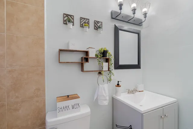 a bedroom with a bed and a flat tv screen on dresser