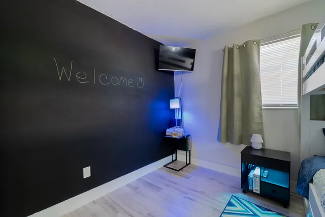 a bedroom with a bed and a chandelier