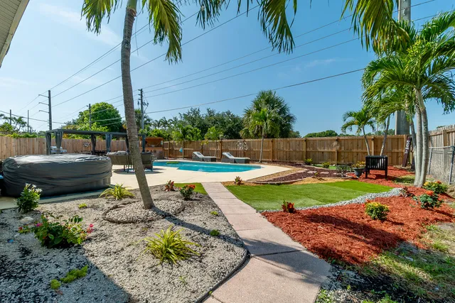 a view of a backyard with table and chairs