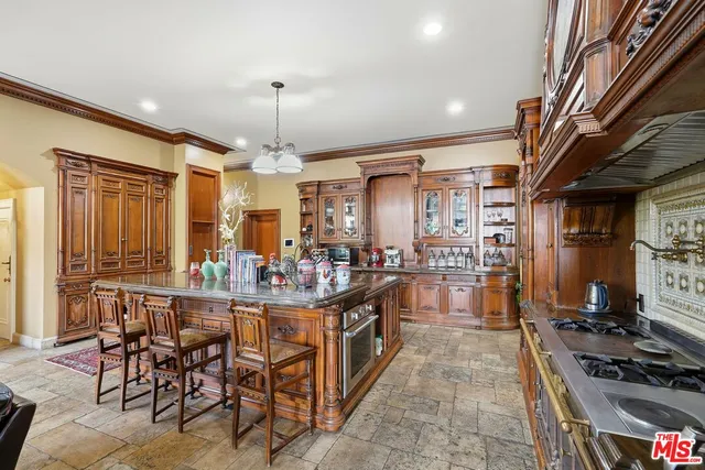 a kitchen with stainless steel appliances granite countertop a stove and cabinets