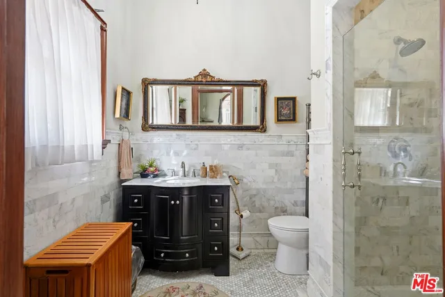 a bathroom with a toilet a sink and mirror