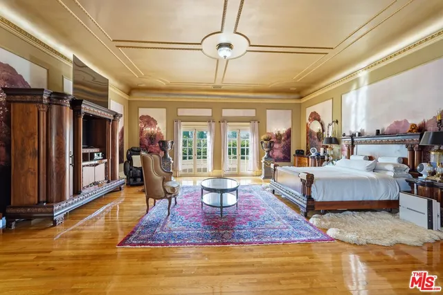 a living room with fireplace furniture and a large window