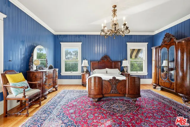 a living room with furniture a chandelier and a rug