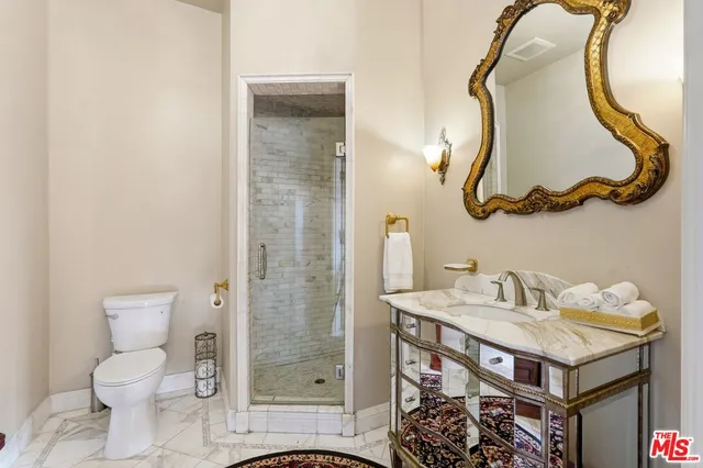a bathroom with a sink toilet and a mirror