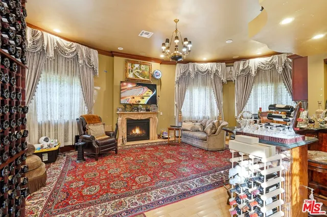 a living room with fireplace furniture and a chandelier